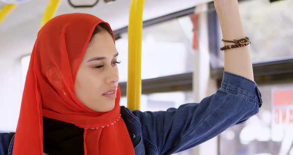 Woman in Hijab Standing While Travelling in The Bus 4k alt