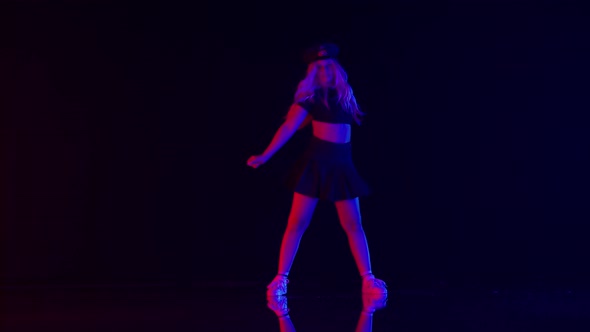 Sexy Young Woman in Policeman Hat Dances in Colorful Stage Lights in Studio alt