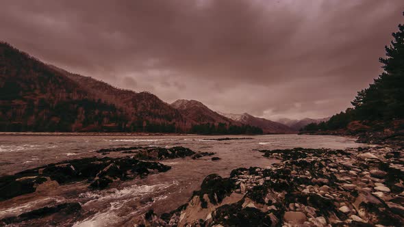 Time Lapse Shot of a River Near Mountain Forest. Huge Rocks and Fast Clouds Movenings. alt