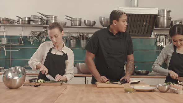 People Cutting Veggies in Kitchen alt