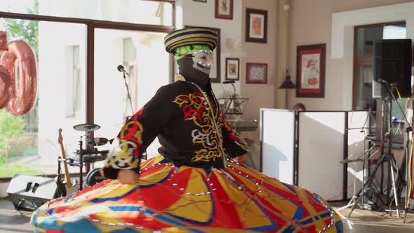 Unrecognizable person dancing national dance tanura indoors. Man show traditional performance alt