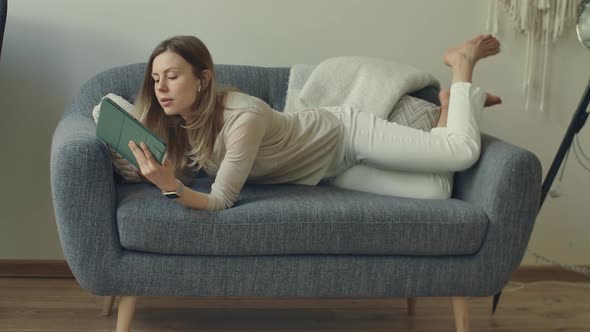 Girl Comes to Sofa Lying Down Start Working with Family Budget