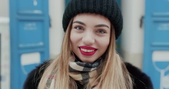 Portrait of Gorgeous Woman With Red Lipstick Makeup Smiling to Camera alt