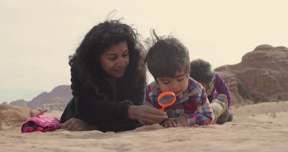 Mother playing with children in Wadi Rum Desert, Jordan