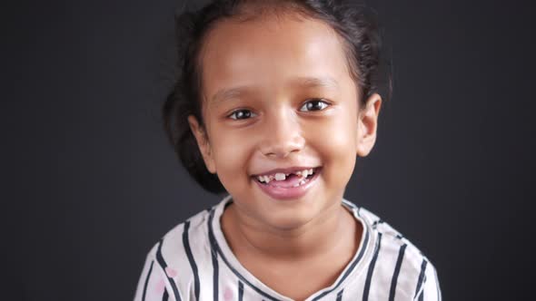 Portrait of Child Girl Looking the Camera and Laughing alt