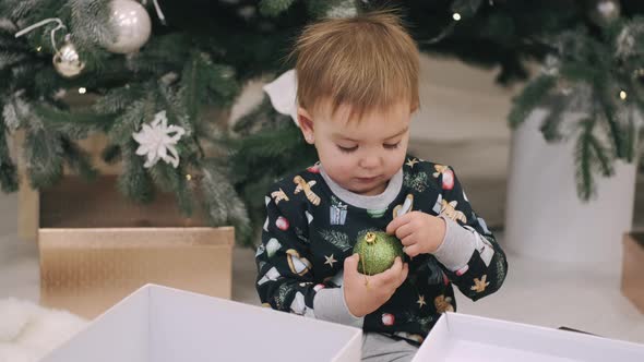 Young Boy Enjoying Christmas Morning Near The Tree alt