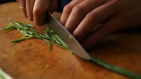 Cutting Fresh Green Onions on a Cutting Board.