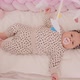 A Tiny Newborn Girl Lies In A Cradle And Looks At Toys - VideoHive Item for Sale