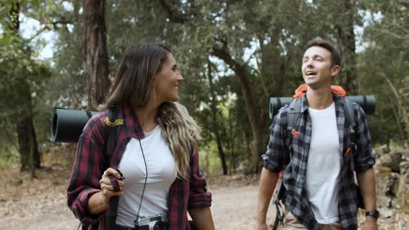 Excited Couple of Hikers Looking Around Admiring Landscape alt