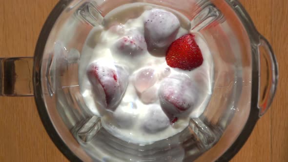 Milkshake with Strawberries and Creamy Milk Yogurt is Mixed in a Blender alt