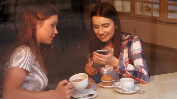 Beautiful women interacting with each other while having coffee alt