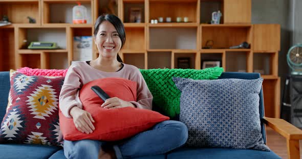 Housewife watch TV at home alt