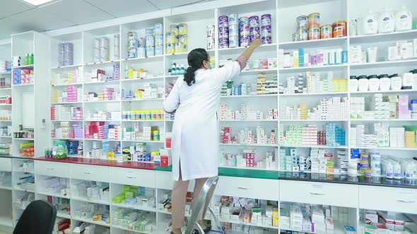 Woman Takes Meds From Pharma Shelf2