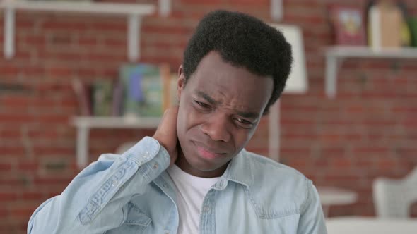 Tired African Man Having Neck Pain alt