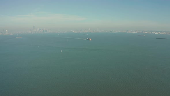Aerial Drone Shot Orbiting Staten Island Ferry in New York Harbor with Skyline alt