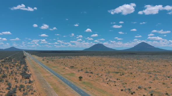 Aerial drone footage of African natural road with car