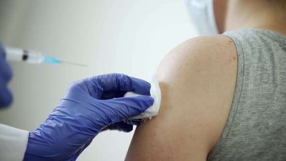 A Healthcare Professional is Vaccinated Against Tickborne Encephalitis alt