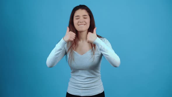 The Optimistic and Enthusiastic Young Woman Shows the Like Signs and Performs Dance Movements to the