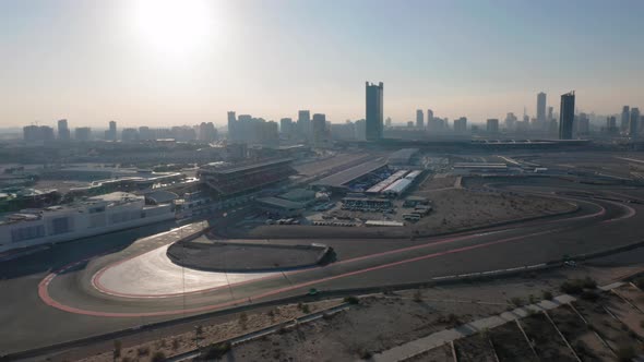 Aerial view overview Dubai Autodrome race track, grand stand, paddock, Dubai skyline