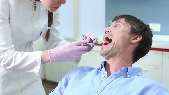 Close up of young male patient receiving injection at dentist alt