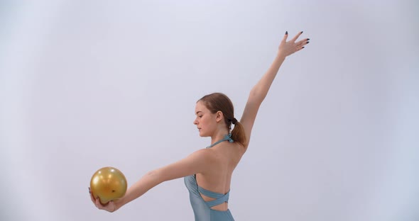 Woman Athlete Performs Callisthenics Exercises with Gymnastic Ball on White Background Sport alt