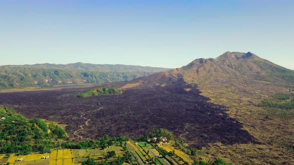 Aerial View of Mountain Slope with Solidified Lava Flow Partly Burnt Bushes. alt