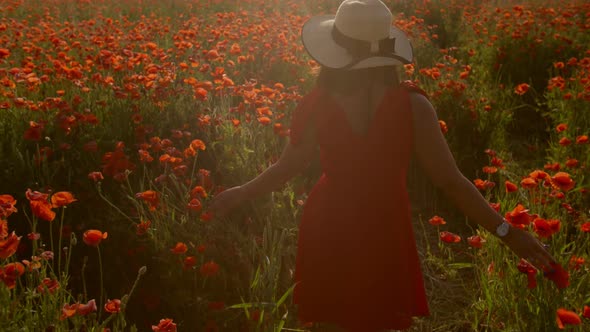 Lady in Red Dress and Hat in a Field with Flowers