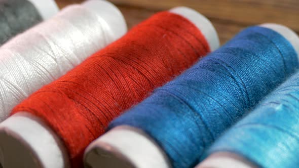 Spools of Colored Thread Close-up. Textile Industry. Sew with a Needle and Thread. Embroider on