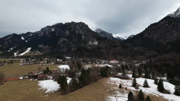 Side to Side aerial drone shot of Neuschwanstein Castle in the winter, Germany. alt