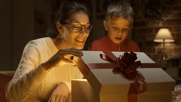 Mother and boy opening a Christmas gift together