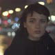 Melancholic Emotive Caucasian Female Standing Staring at You In The City At Night While It Rains - VideoHive Item for Sale