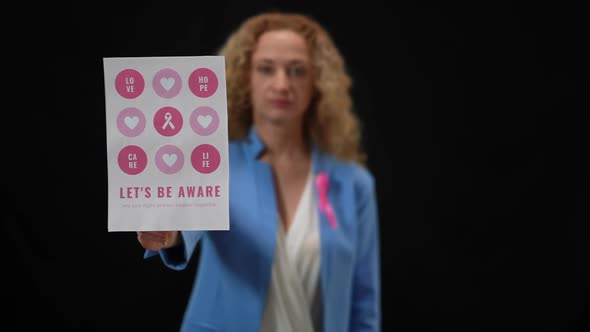 Closeup Breast Cancer Awareness Banner with Blurred Caucasian Elegant Woman at Black Background alt