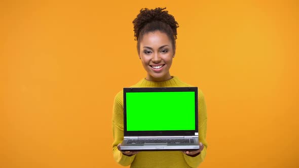 Beautiful Woman Holding Green Screen Laptop, Shopping Online, Bookmakers Office alt