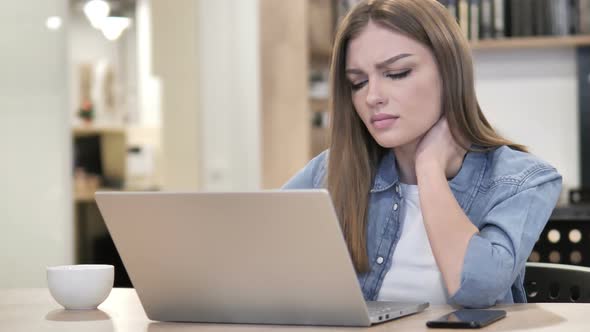Creative Woman with Neck Pain Busy Working on Laptop alt