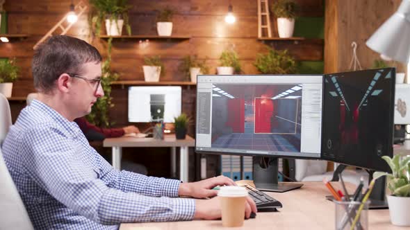 Graphic Designer Taking a Sip of Coffee and Working on a New Desing alt