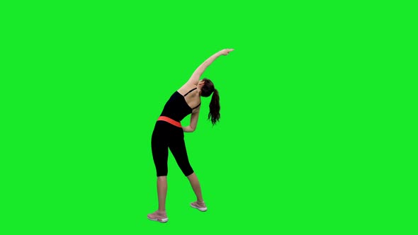 Active Slender Girl in Black Bodysuit Doing Stretching Exercises on Green Screen 