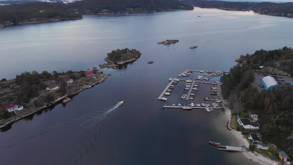 Idyllic location with beach, dock and summer cabins in Kragerofjorden; golden hour alt