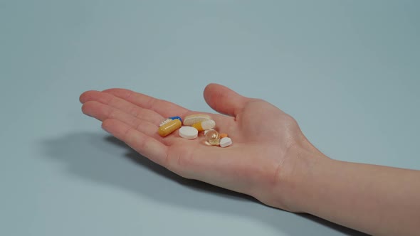 Handful of tablets and capsules alt