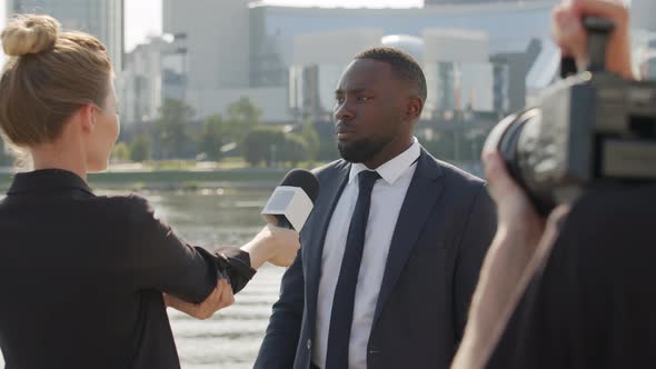 Afro-American Business Man Giving Interview Outdoors alt