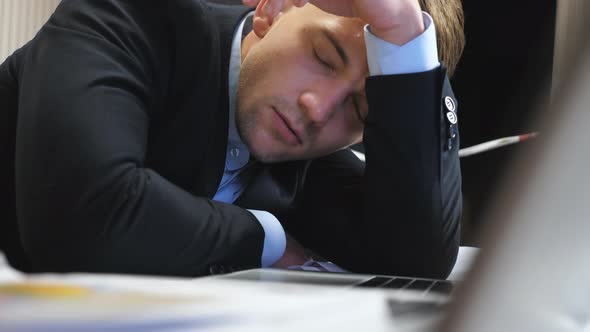 Dolly Shot to Tired Boss in Formal Suit Falling Asleep on Table at Boardroom alt