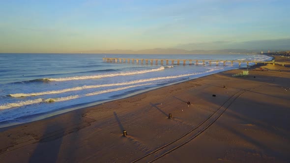 Aerial drone uav view of a lifeguard tower, pier, beach and ocean. alt
