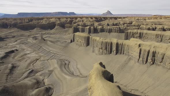 Aerial view flying over desert landscape in the Caineville desert alt