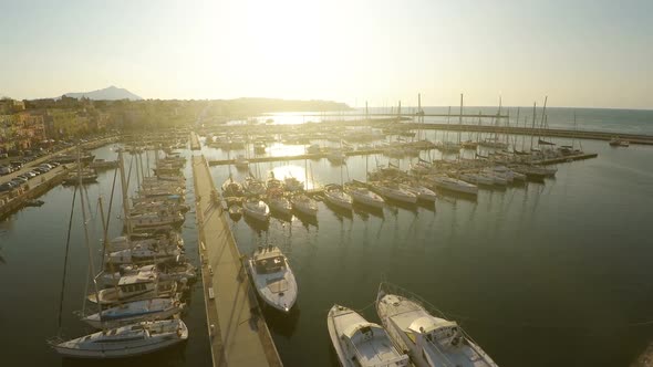 Sunlit Sailing Boats and Yachts Docked at Marina, Mediterranean Tourist City alt