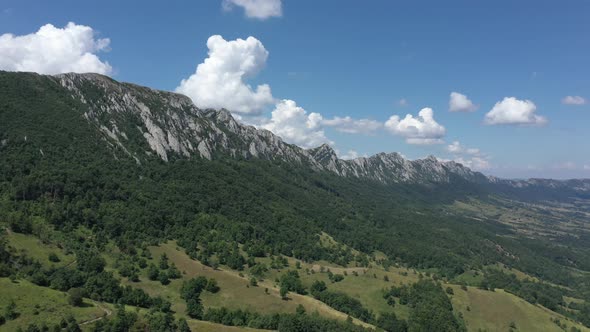 Summer day over the valley and mountain peak of Veliki Krs 4K aerial footage