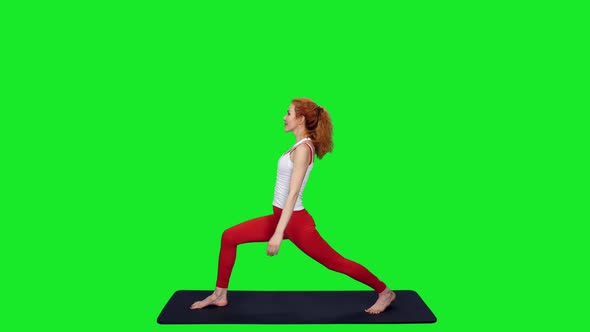Fit Sporty Woman Doing Yoga Pose on Mat Against Green Screen 