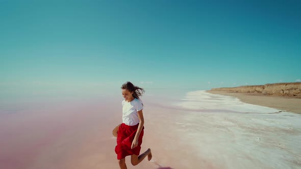 Running Woman By Infinite Horizon Empty Space at Pink Lake During Summer Travel alt