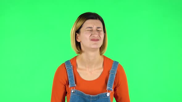 Woman Looking at Camera with Anticipation, Then Very Upset. Green Screen alt