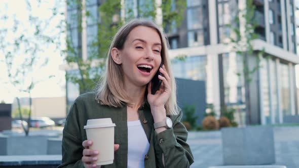 Attractive Positive Blonde Businesswoman Having a Phone Call on a Nice Day alt