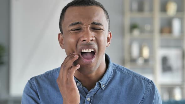 Toothache Young African Man with Tooth Infection alt