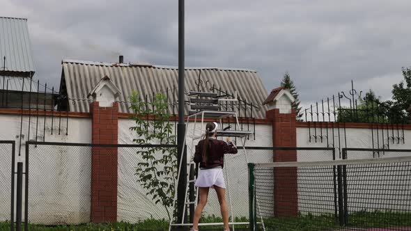 Attractive Woman Playing Tennis on Court